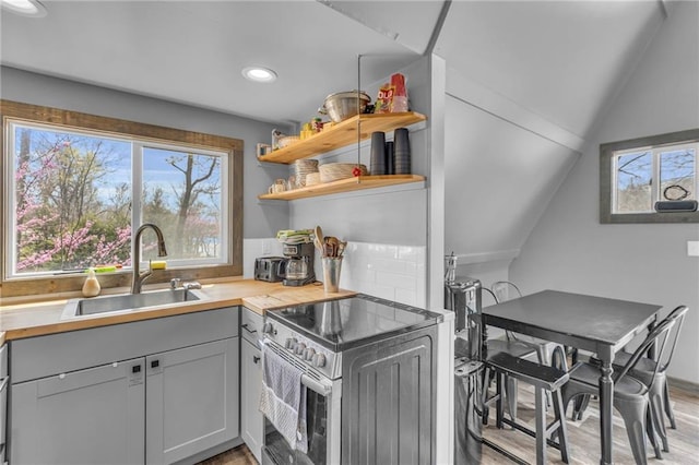 122 W Lou Ann Dr, Lacygne, KS 66040 - kitchen featuring open shelves, wooden counters, a sink, light wood-style flooring, and stainless steel range with electric cooktop