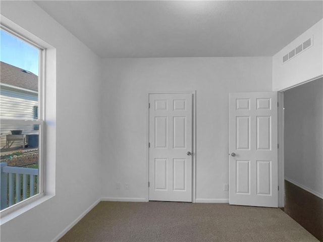 12207 N Pomona Ave, Kansas City, MO 64163 - unfurnished bedroom featuring visible vents, baseboards, and carpet flooring