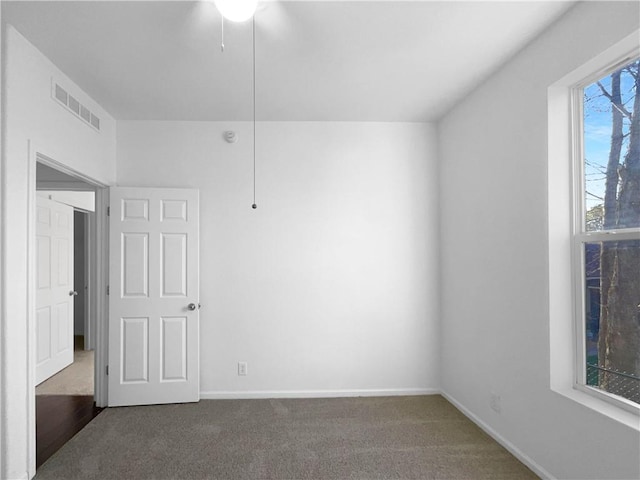 12207 N Pomona Ave, Kansas City, MO 64163 - empty room featuring visible vents, baseboards, and dark colored carpet