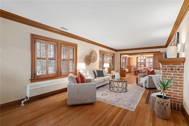 6721 Santa Fe Dr, Overland Park, KS 66204 - living room with ornamental molding, visible vents, radiator, and wood finished floors