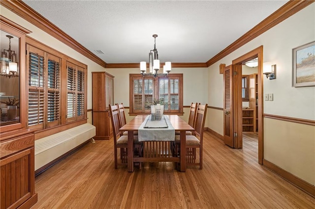 6721 Santa Fe Dr, Overland Park, KS 66204 - dining space with light wood-style floors, ornamental molding, visible vents, a chandelier, and baseboards