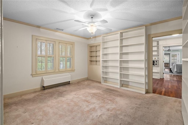 6721 Santa Fe Dr, Overland Park, KS 66204 - unfurnished bedroom featuring baseboards, ornamental molding, a textured ceiling, radiator, and carpet