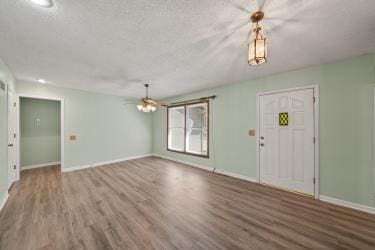 11930 Charlotte St, Kansas City, MO 64146 - entrance foyer featuring wood finished floors, baseboards, and a ceiling fan