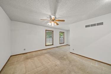 11930 Charlotte St, Kansas City, MO 64146 - carpeted empty room with ceiling fan, a textured ceiling, and baseboards