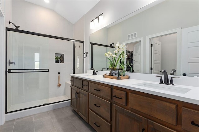 6604 NW 107th Ct, Kansas City, MO 64154 - bathroom featuring a stall shower, a sink, lofted ceiling, and visible vents