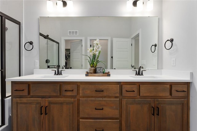 6604 NW 107th Ct, Kansas City, MO 64154 - bathroom with a sink, visible vents, a shower stall, and double vanity
