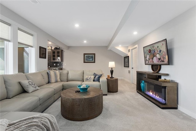 6604 NW 107th Ct, Kansas City, MO 64154 - living area featuring light colored carpet, baseboards, a glass covered fireplace, and recessed lighting
