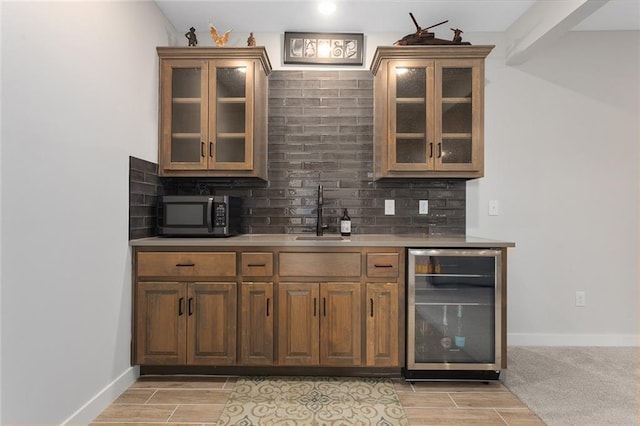 6604 NW 107th Ct, Kansas City, MO 64154 - bar with tasteful backsplash, a sink, stainless steel microwave, wood finish floors, and beverage cooler