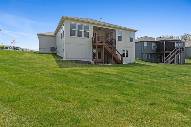 6604 NW 107th Ct, Kansas City, MO 64154 - rear view of house featuring ceiling fan, a sunroom, a yard, stairway, and central AC unit