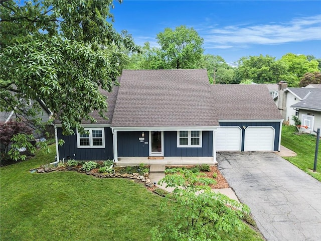 3600 W 48th St, Roeland Park, KS 66205 - view of front of property featuring board and batten siding, a garage, driveway, a shingled roof, and a front yard