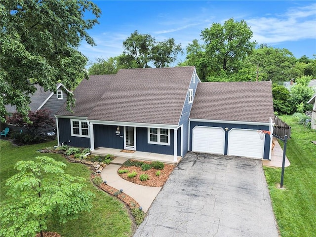 3600 W 48th St, Roeland Park, KS 66205 - view of front of home featuring a garage, a porch, driveway, and roof with shingles