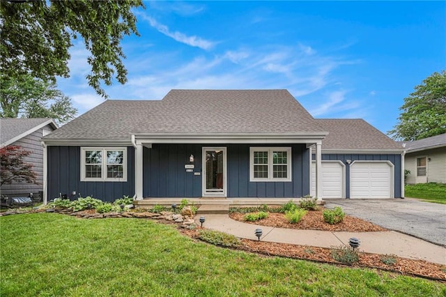 3600 W 48th St, Roeland Park, KS 66205 - view of front facade featuring a porch, board and batten siding, a garage, a front lawn, and driveway