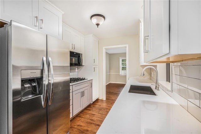 3600 W 48th St, Roeland Park, KS 66205 - kitchen with stainless steel refrigerator with ice dispenser, a sink, black microwave, dark wood-type flooring, and light countertops