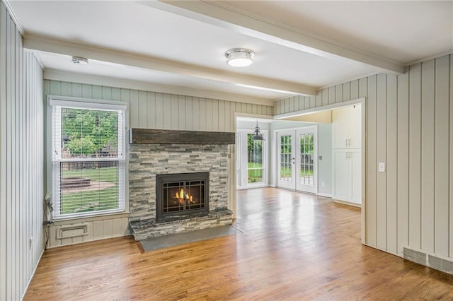 3600 W 48th St, Roeland Park, KS 66205 - unfurnished living room with beamed ceiling, wood finished floors, a stone fireplace, and wooden walls