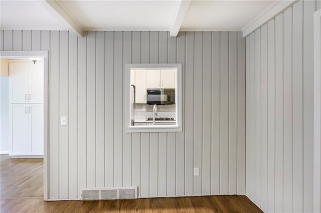 3600 W 48th St, Roeland Park, KS 66205 - empty room featuring beamed ceiling, wood finished floors, and wooden walls