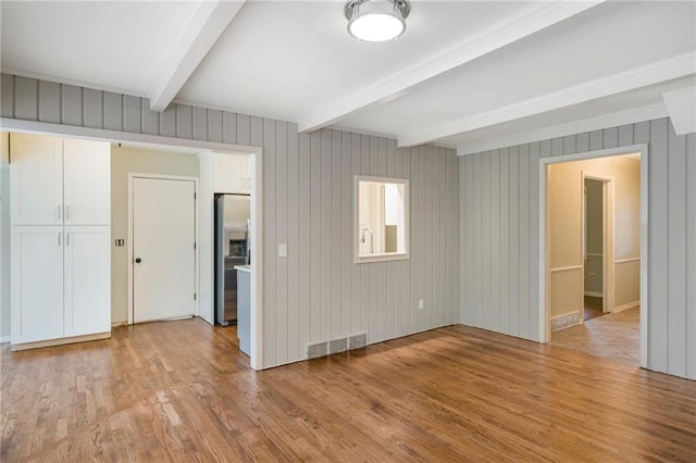 3600 W 48th St, Roeland Park, KS 66205 - empty room with light wood-style flooring and beamed ceiling