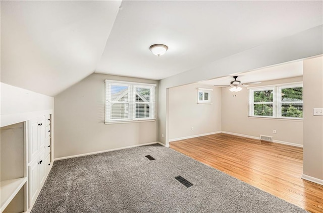 3600 W 48th St, Roeland Park, KS 66205 - additional living space featuring a ceiling fan, baseboards, light wood-style flooring, lofted ceiling, and light carpet