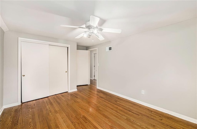 3600 W 48th St, Roeland Park, KS 66205 - unfurnished bedroom with baseboards, wood finished floors, a closet, and ceiling fan