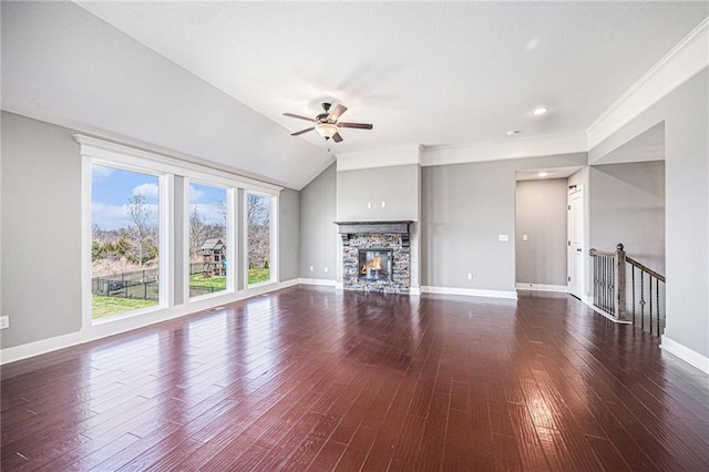 unfurnished living room with dark wood-style floors, baseboards, a stone fireplace, and ceiling fan