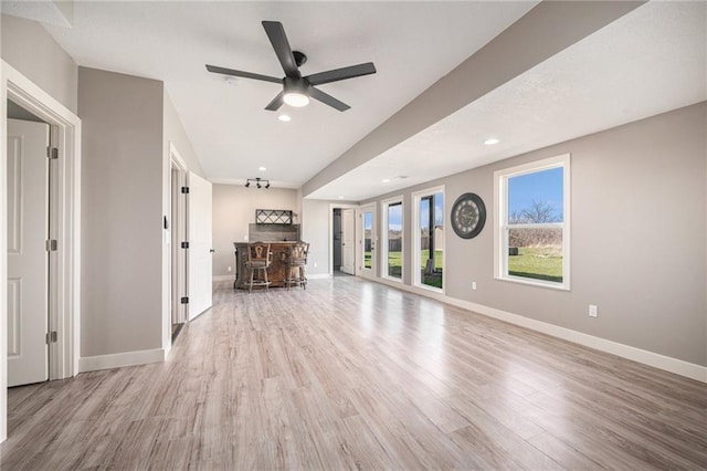 unfurnished living room featuring wood finished floors, baseboards, a ceiling fan, and recessed lighting