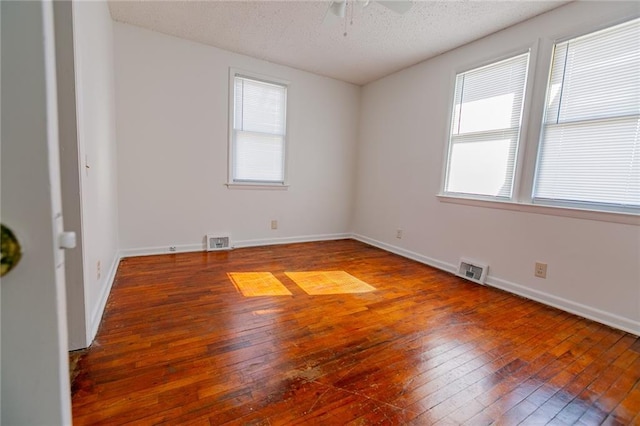 6936 Kensington Ave, Kansas City, MO 64132 - unfurnished room featuring hardwood / wood-style flooring, a ceiling fan, a textured ceiling, and baseboards