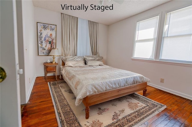 6936 Kensington Ave, Kansas City, MO 64132 - bedroom with dark wood-type flooring, baseboards, and a textured ceiling