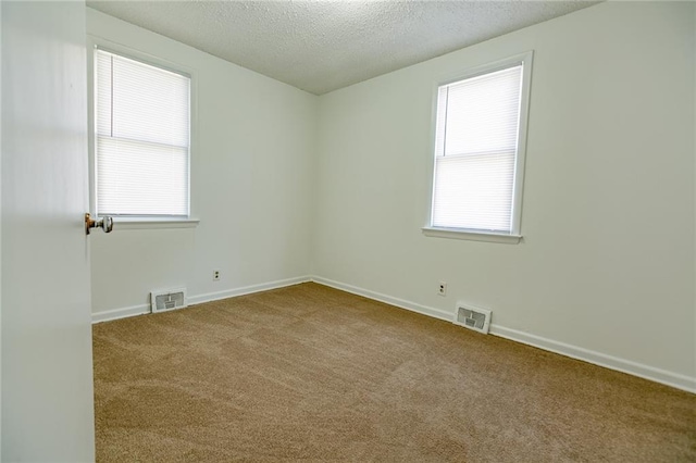 6936 Kensington Ave, Kansas City, MO 64132 - carpeted spare room featuring a textured ceiling and baseboards