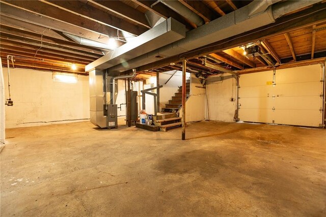 6936 Kensington Ave, Kansas City, MO 64132 - basement with heating unit, gas water heater, and stairway
