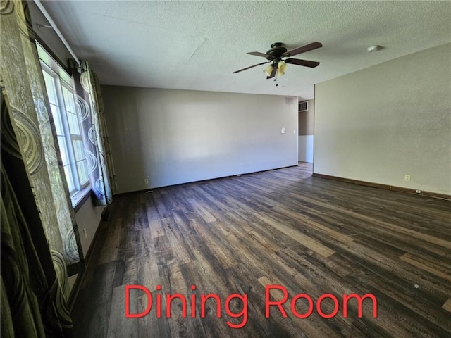 415 N Western St, Girard, KS 66762 - empty room with dark wood-style flooring, baseboards, a textured ceiling, visible vents, and ceiling fan