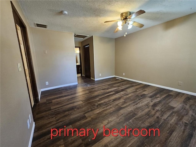 415 N Western St, Girard, KS 66762 - unfurnished room featuring dark wood-style flooring, baseboards, a ceiling fan, and a textured ceiling