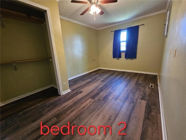 415 N Western St, Girard, KS 66762 - unfurnished bedroom with crown molding, baseboards, ceiling fan, and wood finished floors