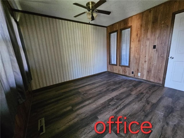 415 N Western St, Girard, KS 66762 - spare room with wood finished floors, wood walls, and a ceiling fan