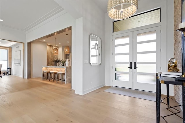 entryway with french doors, baseboards, and wood finished floors