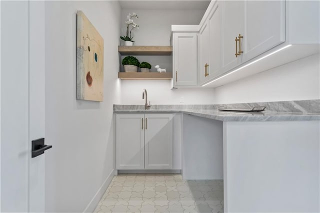 interior space with a sink and baseboards