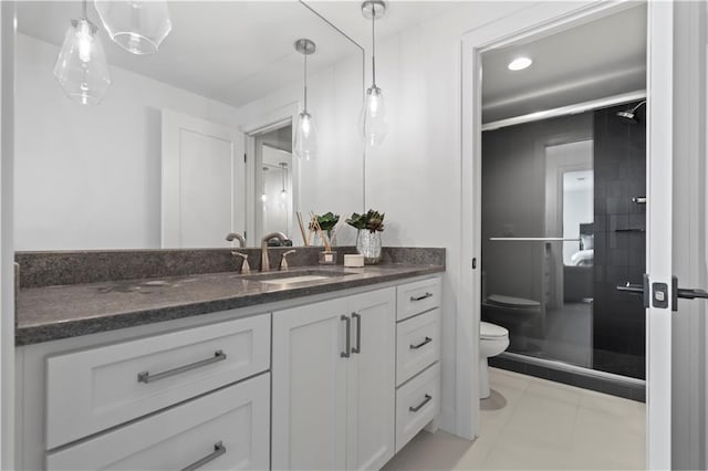 bathroom featuring vanity, a stall shower, and toilet