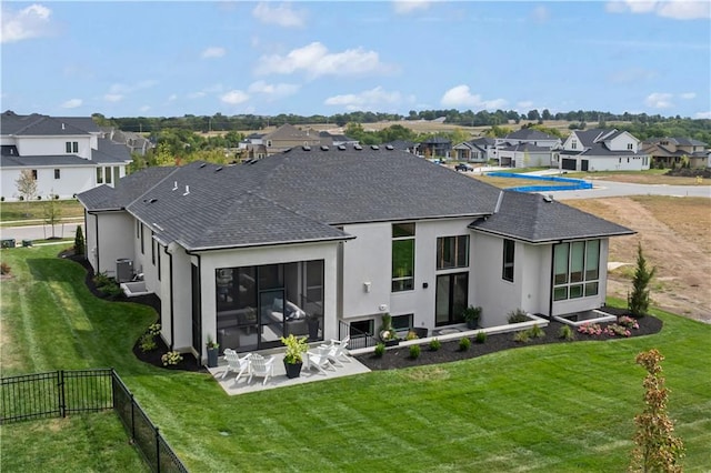 back of property with a patio, a shingled roof, stucco siding, and a residential view