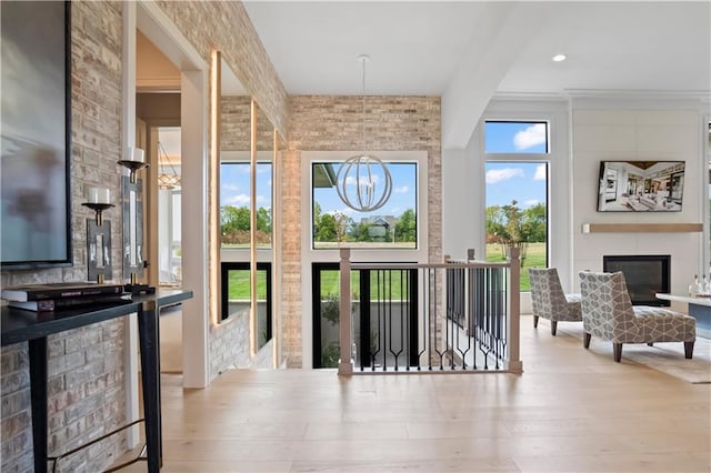 4506 W 136th Ter, Leawood, KS 66224 - doorway to outside featuring wood finished floors and a fireplace