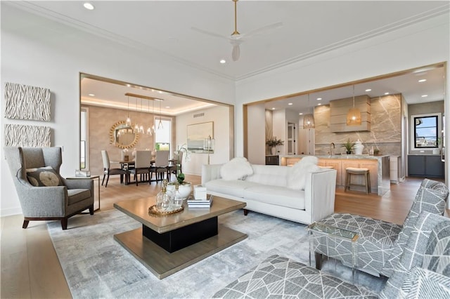 4506 W 136th Ter, Leawood, KS 66224 - living area featuring light wood finished floors, recessed lighting, ornamental molding, and a ceiling fan