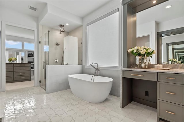 4506 W 136th Ter, Leawood, KS 66224 - full bath with a shower stall, vanity, a freestanding bath, and tile patterned floors