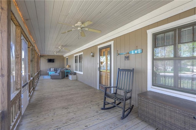 sunroom / solarium with an outdoor living space, a healthy amount of sunlight, and ceiling fan