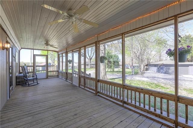 unfurnished sunroom with ceiling fan