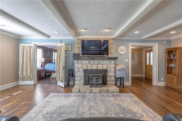 living room with a wealth of natural light, baseboards, and a textured ceiling
