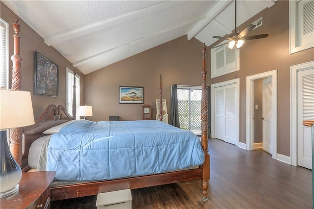 bedroom featuring two closets, beamed ceiling, high vaulted ceiling, wood finished floors, and baseboards