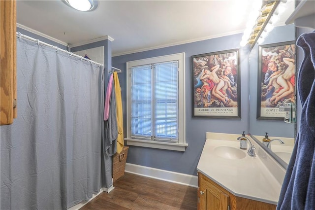 full bath featuring vanity, baseboards, ornamental molding, and wood finished floors