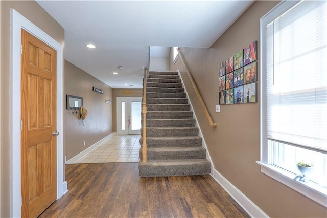 stairway with recessed lighting, baseboards, and wood finished floors