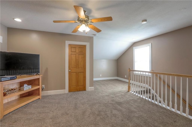 bonus room featuring ceiling fan, baseboards, vaulted ceiling, and carpet floors