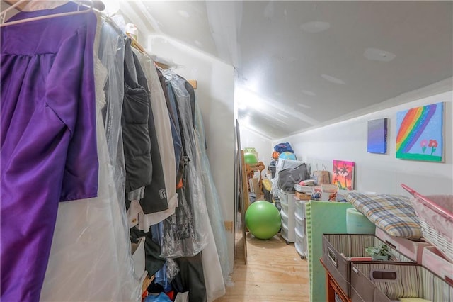 spacious closet featuring lofted ceiling and wood finished floors