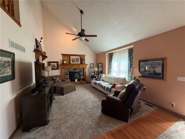1200 Susan St, Kearney, MO 64060 - living area featuring ceiling fan, a textured ceiling, wood finished floors, vaulted ceiling, and a fireplace