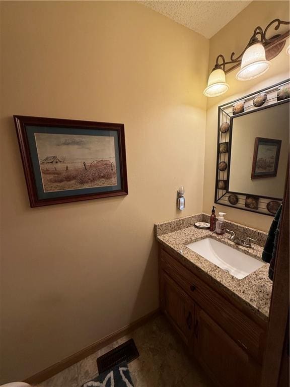 1200 Susan St, Kearney, MO 64060 - bathroom featuring vanity, a textured ceiling, and baseboards