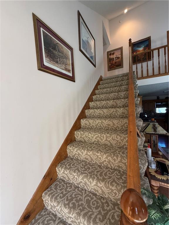 1200 Susan St, Kearney, MO 64060 - staircase with wood finished floors